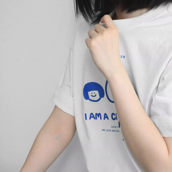 A man in a t-shirt that reads "I am a child of God," standing against a neutral background.